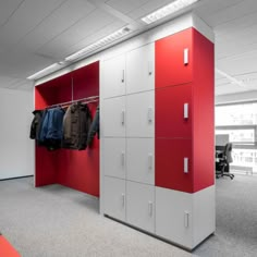 a red and white closet with clothes hanging on it