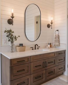 a bathroom with two sinks and a large mirror on the wall over it's counter