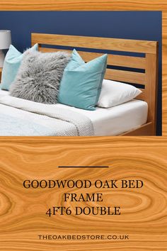 the bed frame is made with wood and has blue pillows on it, along with a wooden headboard