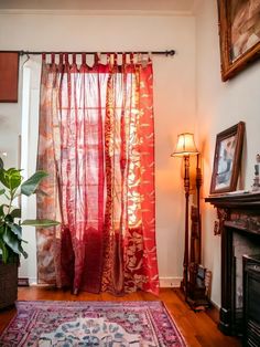 a living room with a red curtain and rug