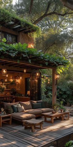 an outdoor living area with couches, tables and plants on the roof decking