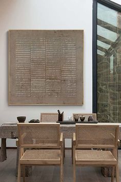 two wooden chairs sitting in front of a table