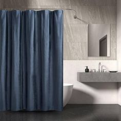 a bathroom with a blue shower curtain next to a sink