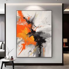 an abstract painting hangs on the wall in a modern living room