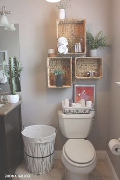 a white toilet sitting inside of a bathroom next to a trash can and garbage can