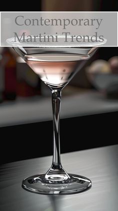 a close up of a martini glass on a table with the words contemporary martini trend