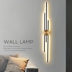 a wall lamp is mounted on the side of a white wall next to a couch