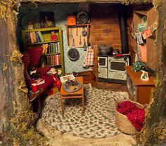 a doll house is shown with furniture and bookshelves in the room, as well as an old fashioned stove