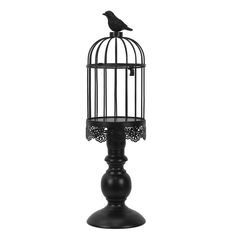 a black bird in a cage on top of a stand with a white background photo