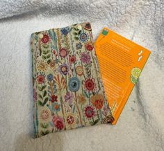 Kew garden tapestry fabric book sleeve, ideal to keep your book corners and pages from getting bent or ripped when you put the book in your bag or in a draw.  It is slighted padded with wadding each side to keep thing safe. The book sleeve has two poppers on the top to stop your book from sliding out. A paperback  (13cm x 19.7cm) up to about 450 pages approx maybe a bit more will fit easily into this sleeve and a hardback (20.3 x 13.5cm) up to about 400 pages approx. Please remember these are ha Fabric Book Sleeve, Book Protector, Book Pouch, Book Corners, Tapestry Fabric, Book Sleeve, Handmade Book, Fabric Book, Book Accessories