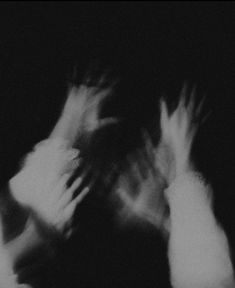 black and white photograph of two hands reaching for something