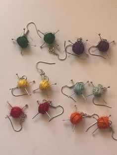 there are many balls of yarn on the table and pins in each one, all different colors