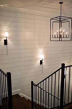 the lights are on above the railing in the house's entryway, which is painted white