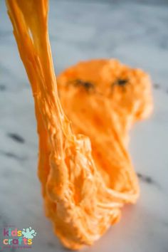 an orange piece of food that is on a table