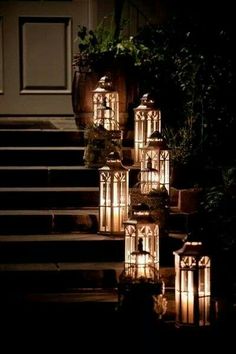 several lit candles sitting on the steps in front of a building