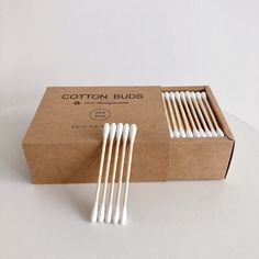 cotton buds in a cardboard box on a white table