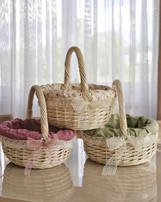 two wicker baskets sitting on top of a table