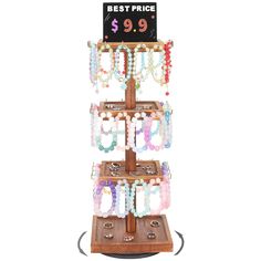 a wooden stand with bracelets on it and a price sign above the display for $ 9 99