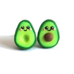 two small green avocados with eyes and noses