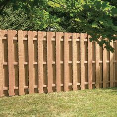 a wooden fence is shown in the grass