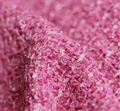 close up view of pink fabric textured with sequins and metallic flakes