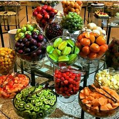 a table topped with lots of different types of fruits and veggies in bowls