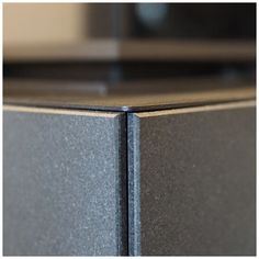 an image of a close up view of the corner of a metal cabinet or shelf