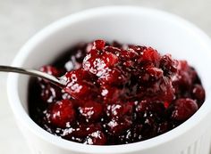 cranberry sauce in a white bowl with a spoon