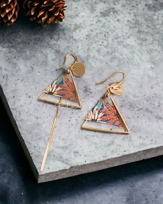 These triangle mismatch earrings feature delicate flower elements, creating a playful yet sophisticated ensemble. Elevate your style with the contemporary charm of these drop dangle earrings, perfect for making a stylish statement that effortlessly blends geometric precision with floral allure. **Product name** Triangle Flower Mismatch Geometric Drop Dangle Earrings **Size** Longer side: Length: 7.7 cm; Width: 2.4 cm Shorter side: Length: 3.6 cm; Width: 2.4 cm **Packaging** - Each order is thoughtfully packaged, arriving in a paper box accompanied by an exquisite silky jewellery bag. - For environmentally friendly, we have opted not to include the invoice and packing list by default. Should you require these documents, please do not hesitate to inform us. **Delivery** - Free UK Shipping us Triangle Earrings Dangle, Unique Handmade Triangle Earrings, Elegant Triangle Metal Earrings, Mismatch Earrings, Gold Triangle Metal Earrings, Multicolor Flower-shaped Artsy Earrings, Flower Elements, Mismatched Earrings, Earrings Geometric