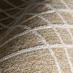 a close up view of the back end of a bed with brown and white carpet