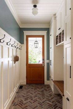 the hallway is clean and ready to be used as a mudroom or laundry room