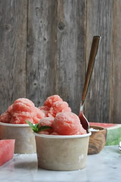 watermelon souffle in a bowl with a spoon next to it on a table