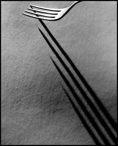 a fork casting a shadow on the wall