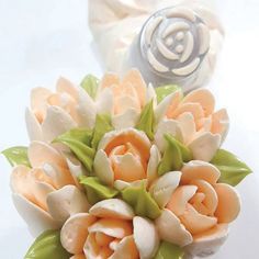 a bouquet of flowers sitting on top of a table next to a roll of toilet paper