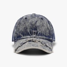 an old blue hat with holes on the front and side, against a white background