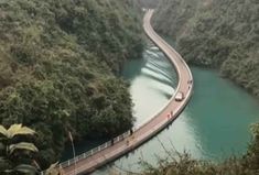 a car driving down a road next to a river