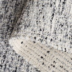 the texture of an upholstered fabric with black and white dots is shown in closeup