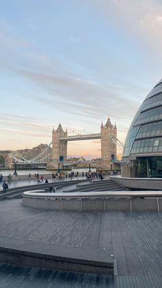 people are walking around in front of the tower bridge