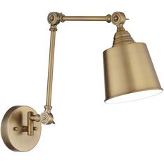 an antique brass finish wall light with a white shade on the top and bottom arm