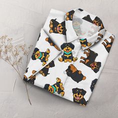 a white shirt with bears on it and a flower in the corner next to it