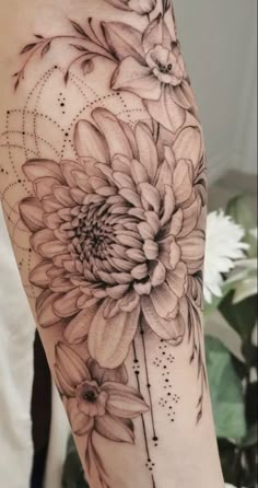 a black and white photo of a flower on the right arm with dots in it