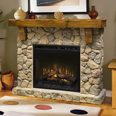 a living room with a fire place in the center and a painting on the wall