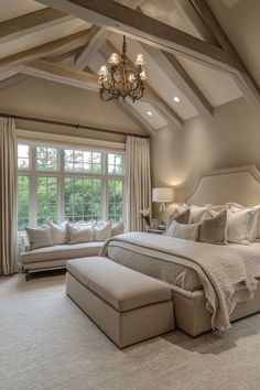 a large bed sitting under a window in a bedroom