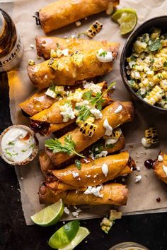 mexican street food with corn, salsa and sour cream on parchment paper next to it