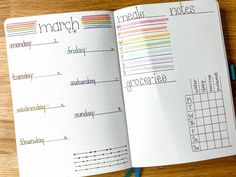 an open planner with the words march written in different colors on it and a blue pen next to it