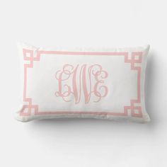 a pink and white monogrammed pillow with the word's initials on it