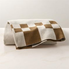 a brown and white checkered towel on a counter