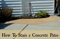 a man is cleaning the driveway with a mop in front of a house that has a sign on it