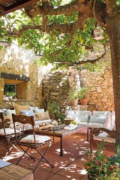 an outdoor living area with furniture and trees