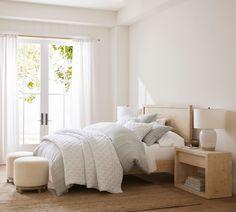 a bedroom with white walls and furniture